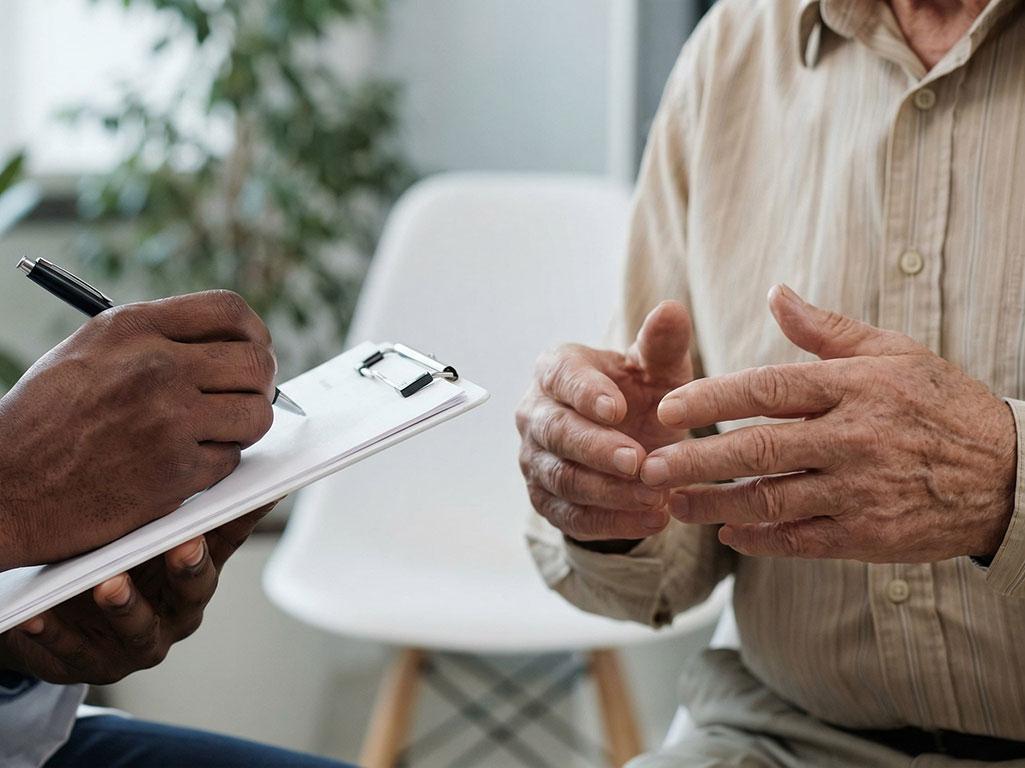 Doctor taking notes during patient consultation